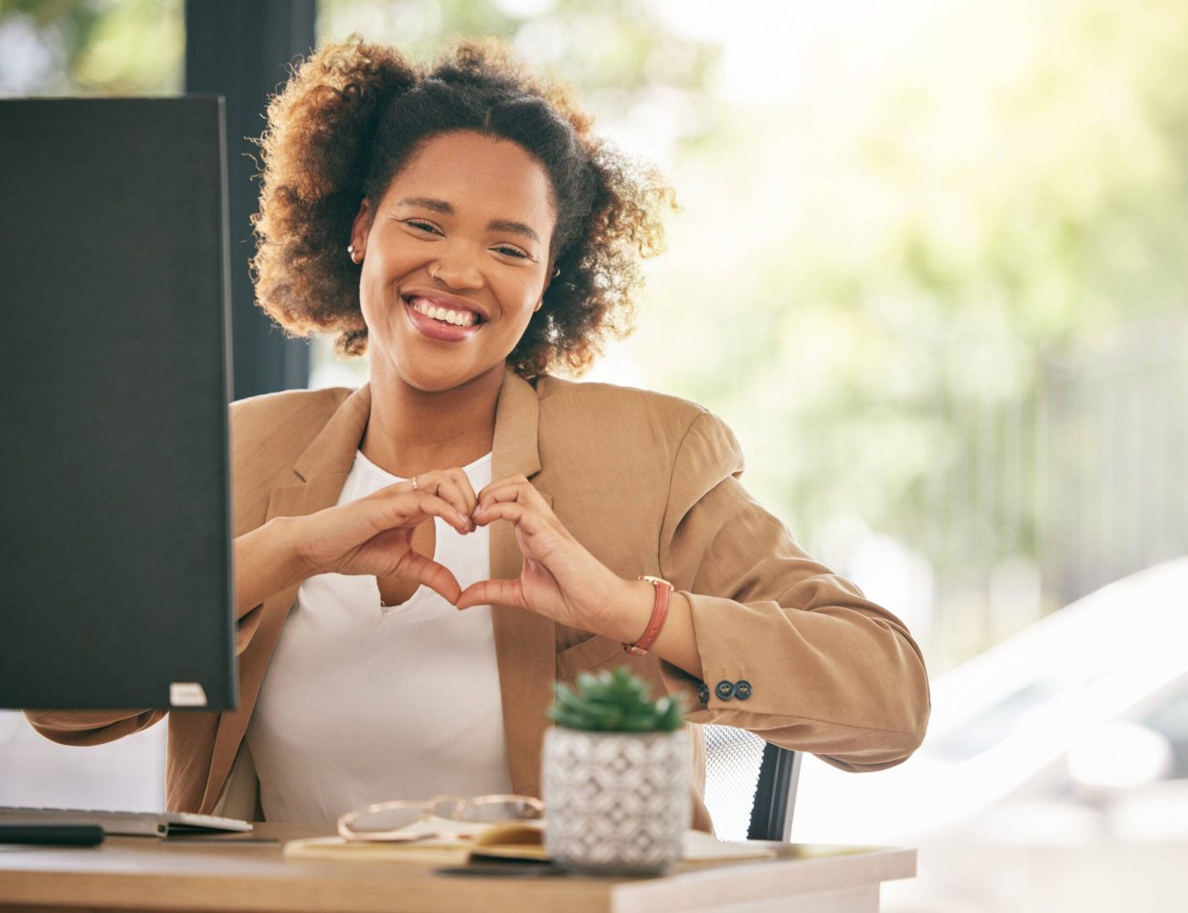 portrait-business-woman-smile-with-heart-hands-office-care-kindness-love-emoji-happy-young-african-female-worker-with-finger-shape-thank-you-trust-like-support-agency Portrait, business woman and smile with heart hands in office for care, kindness or love emoji. Happy young African female worker with finger shape for thank you, trust and like of support in agency.